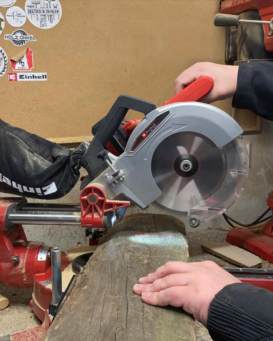 Person using a saw to cut wood