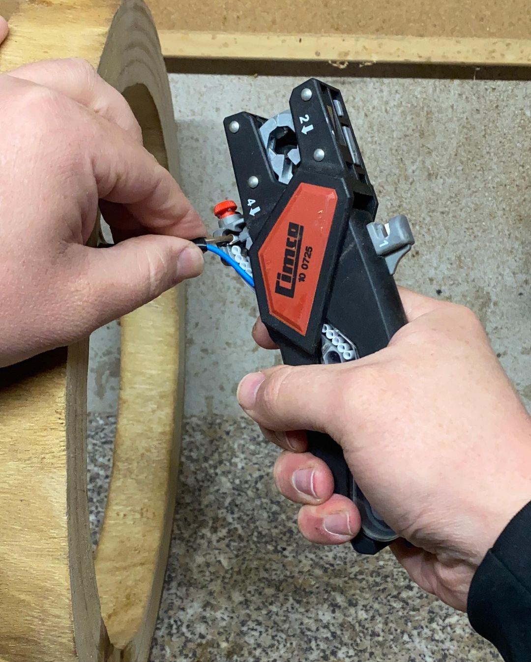 Person using a wire crimping tool