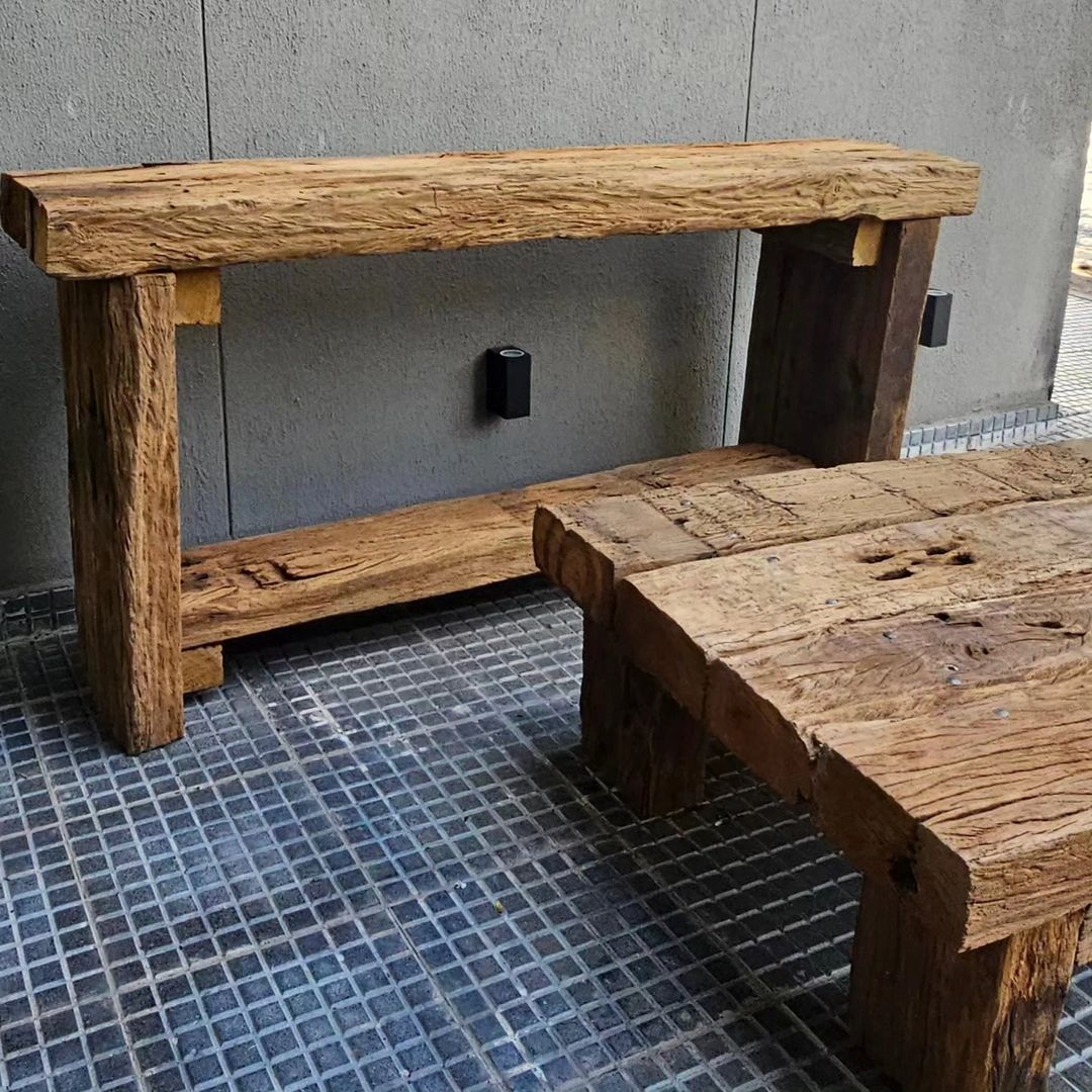 A robust wooden bench and table set exhibiting a rustic charm