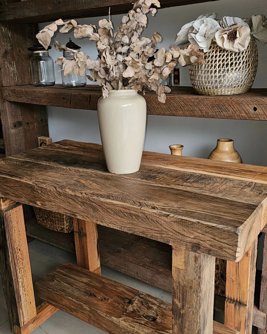 Rustic wooden console table with decorative dried foliage