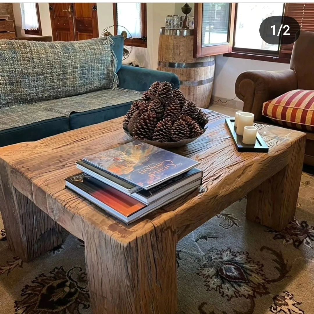 A rugged, wood-centric living room featuring a solid wooden coffee table with raw edges