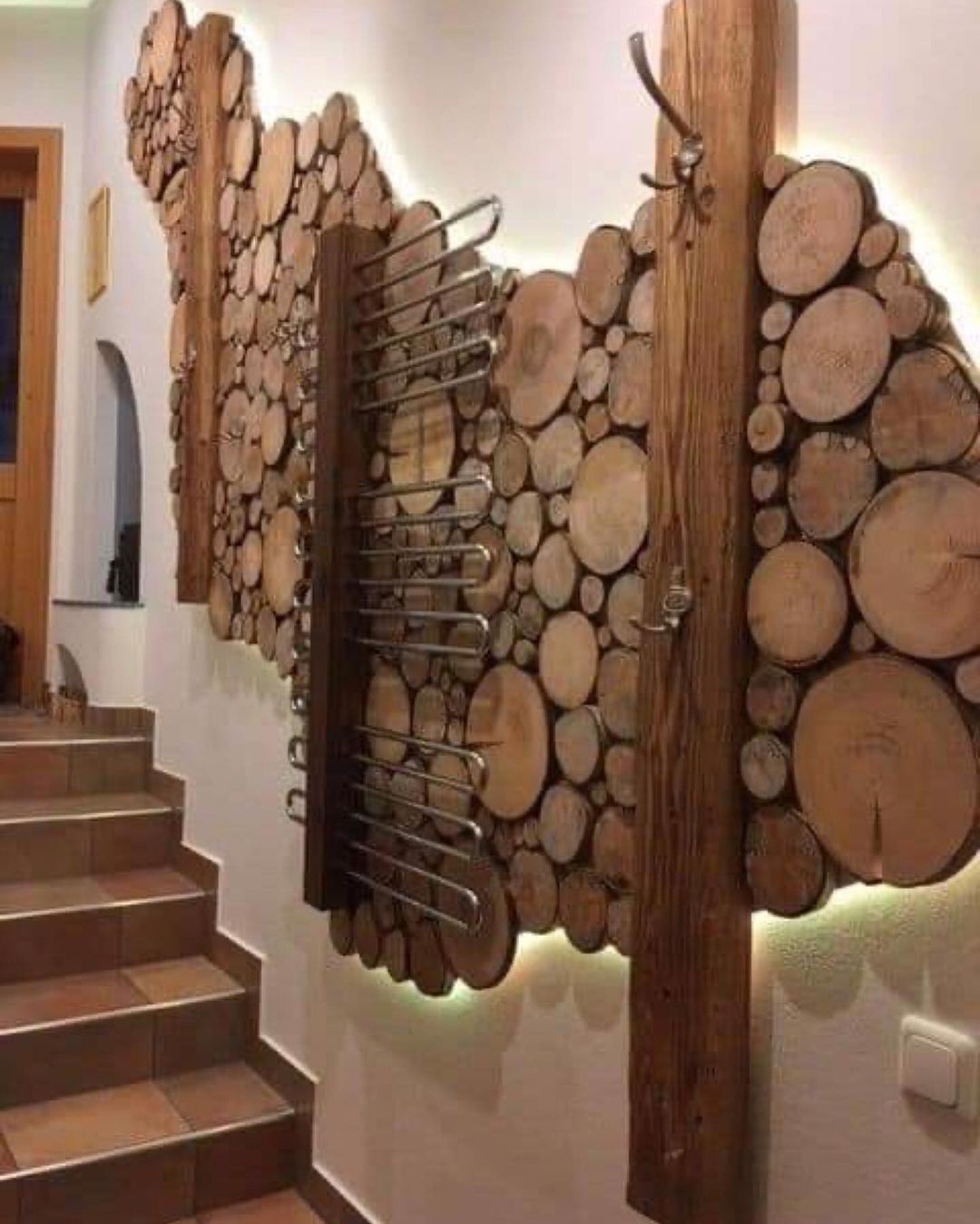 A wall adorned with neatly arranged cross-sections of logs creating a natural and rustic decor element.