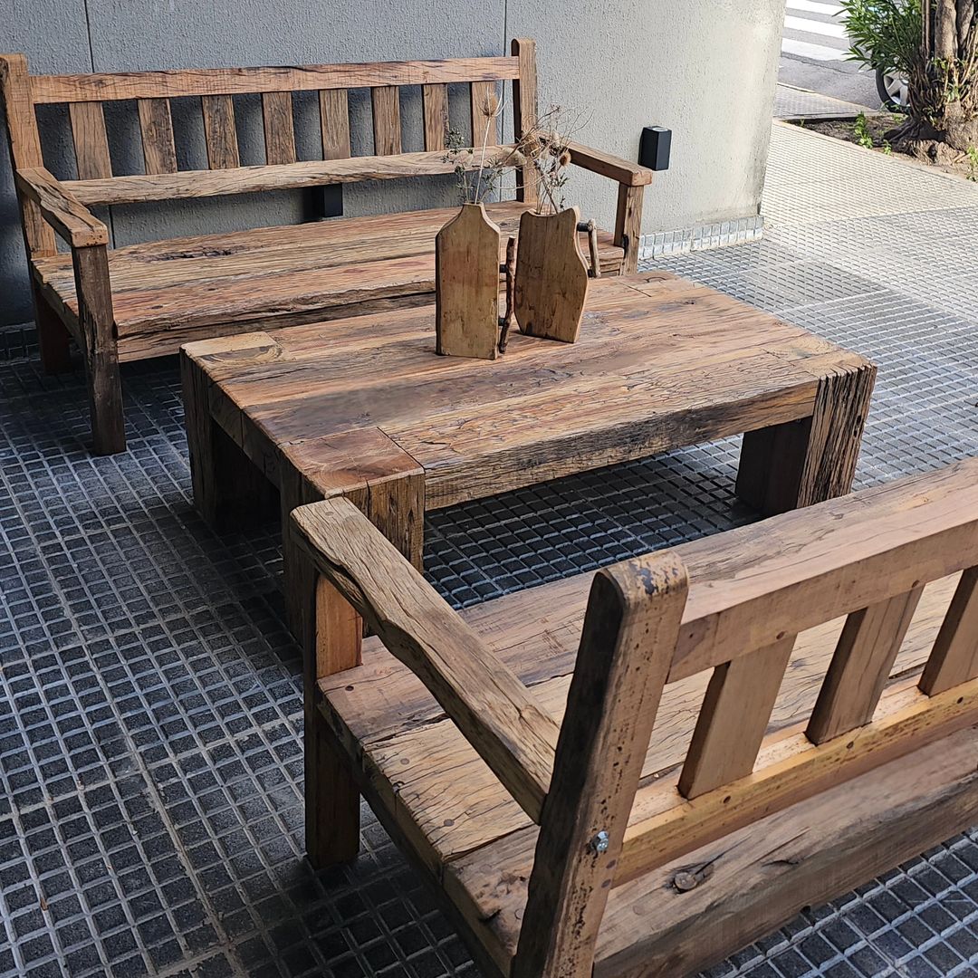 Rustic wooden outdoor furniture set with a bench, chairs, and a table