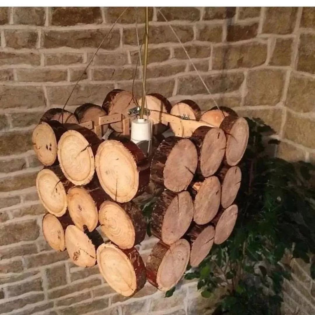 A rustic chandelier made with cross-sections of wood logs.