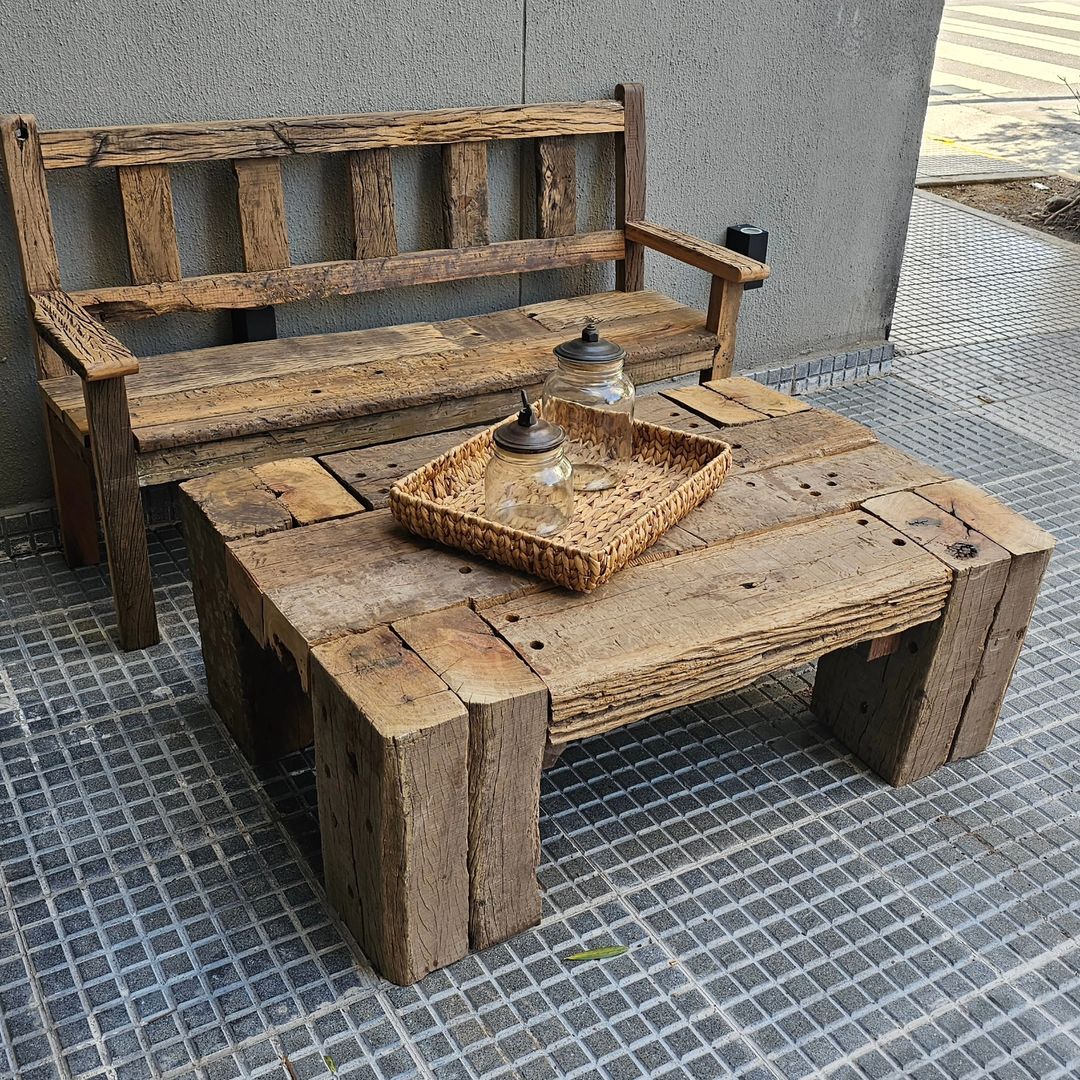 Rustic outdoor seating arrangement with wooden bench and coffee table