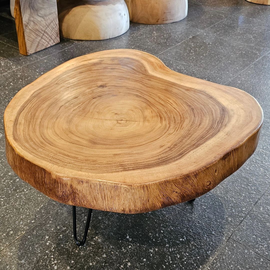 A rustic wooden coffee table with hairpin legs