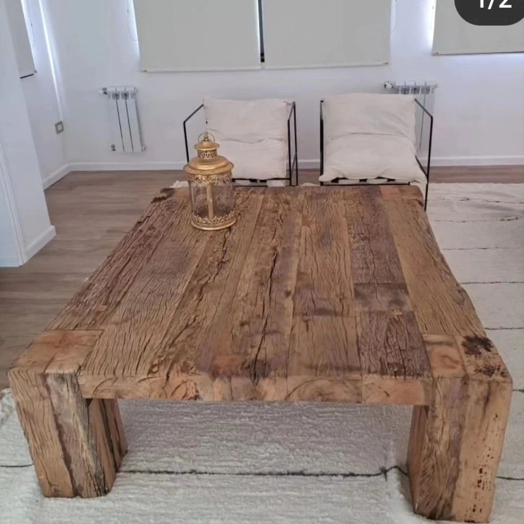 A rustic wooden coffee table with a decorative lantern centerpiece