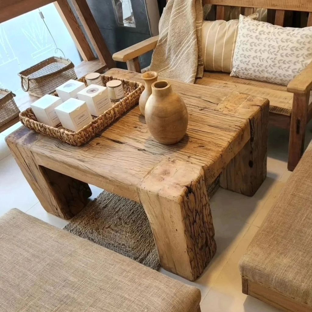 A rustic wooden coffee table set in a cozy nook