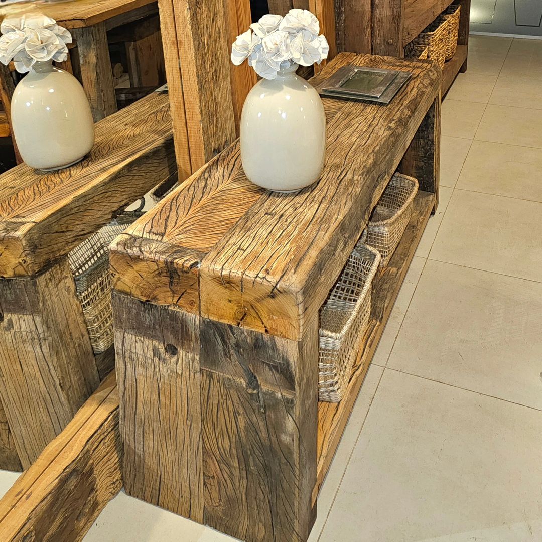 A rustic wooden console table with wicker baskets