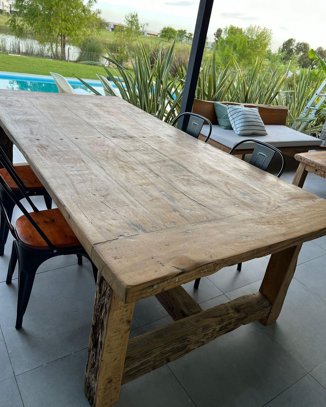 A rustic wooden dining table with rugged textures and sturdy design