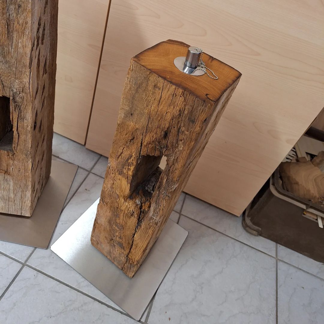 A uniquely designed rustic wooden log converted into a dispenser stand