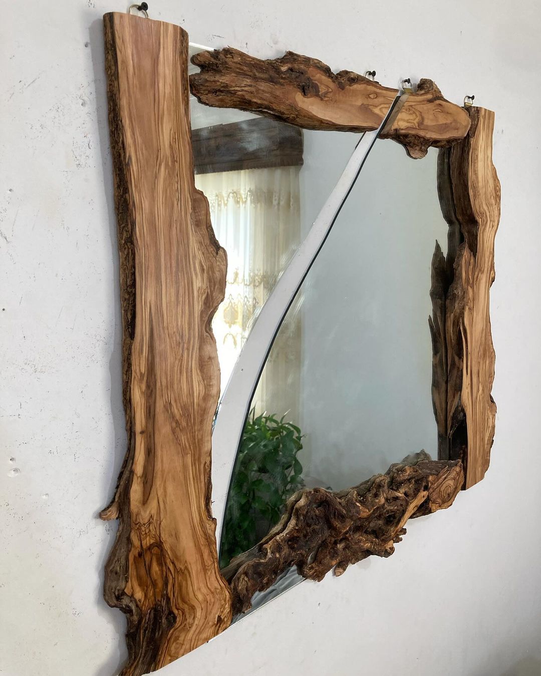 A unique wooden mirror frame with natural edges and intricate grain patterns