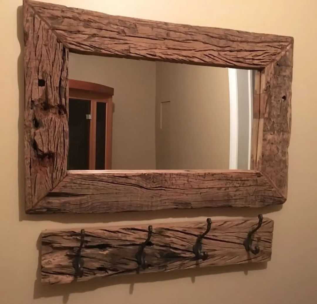 Rustic wooden mirror frame with a matching shelf and iron hooks