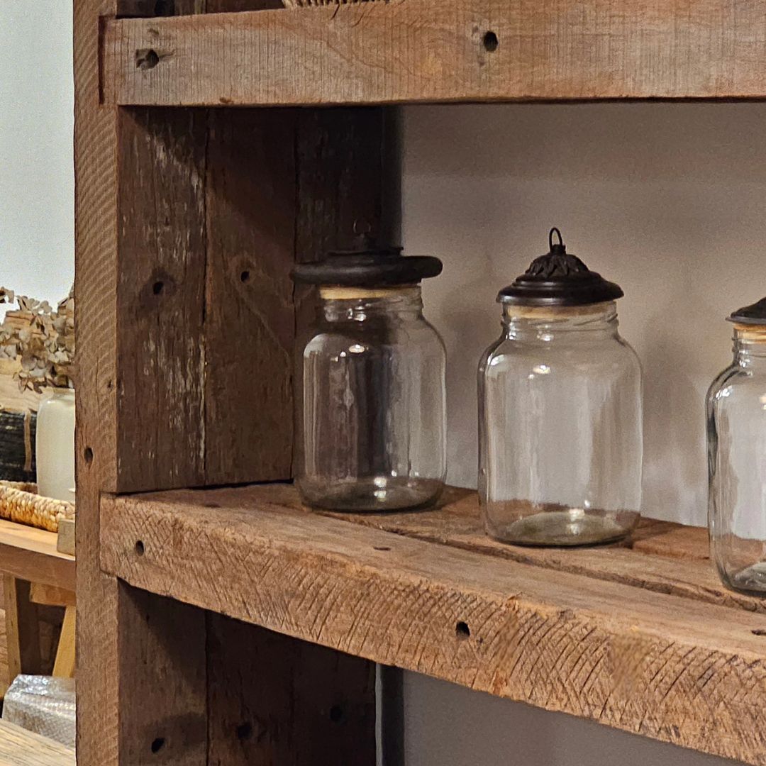 Rustic wooden shelf with vintage glass jars