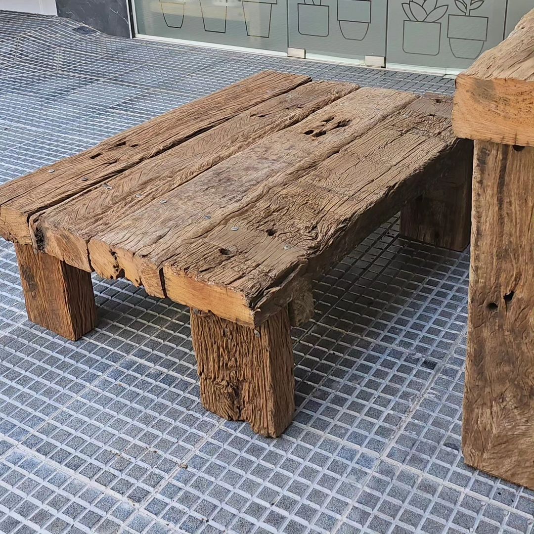 A rustic wooden table with textured surface and sturdy legs