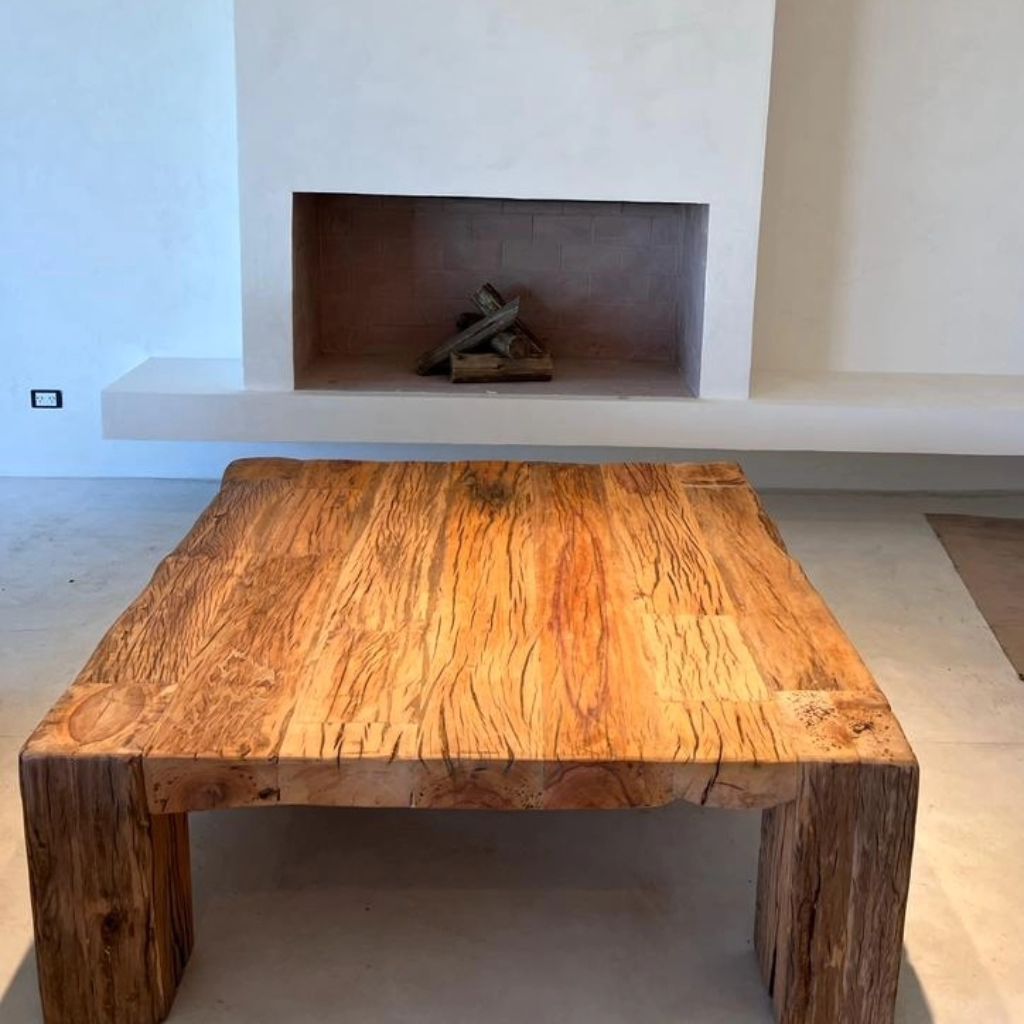 A rustic wooden table with rich textures adding warmth to a minimalist room