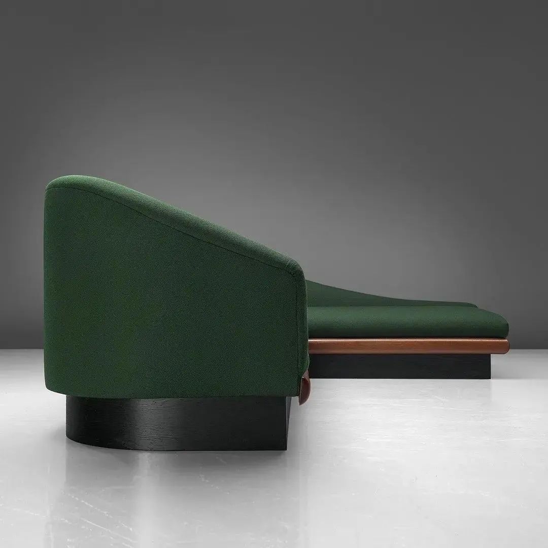 A minimalist green daybed with sleek lines and a subtle merge of textures