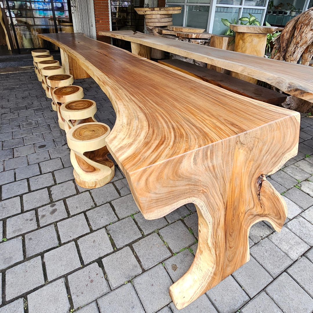 A beautifully crafted natural wooden table with matching stump stools