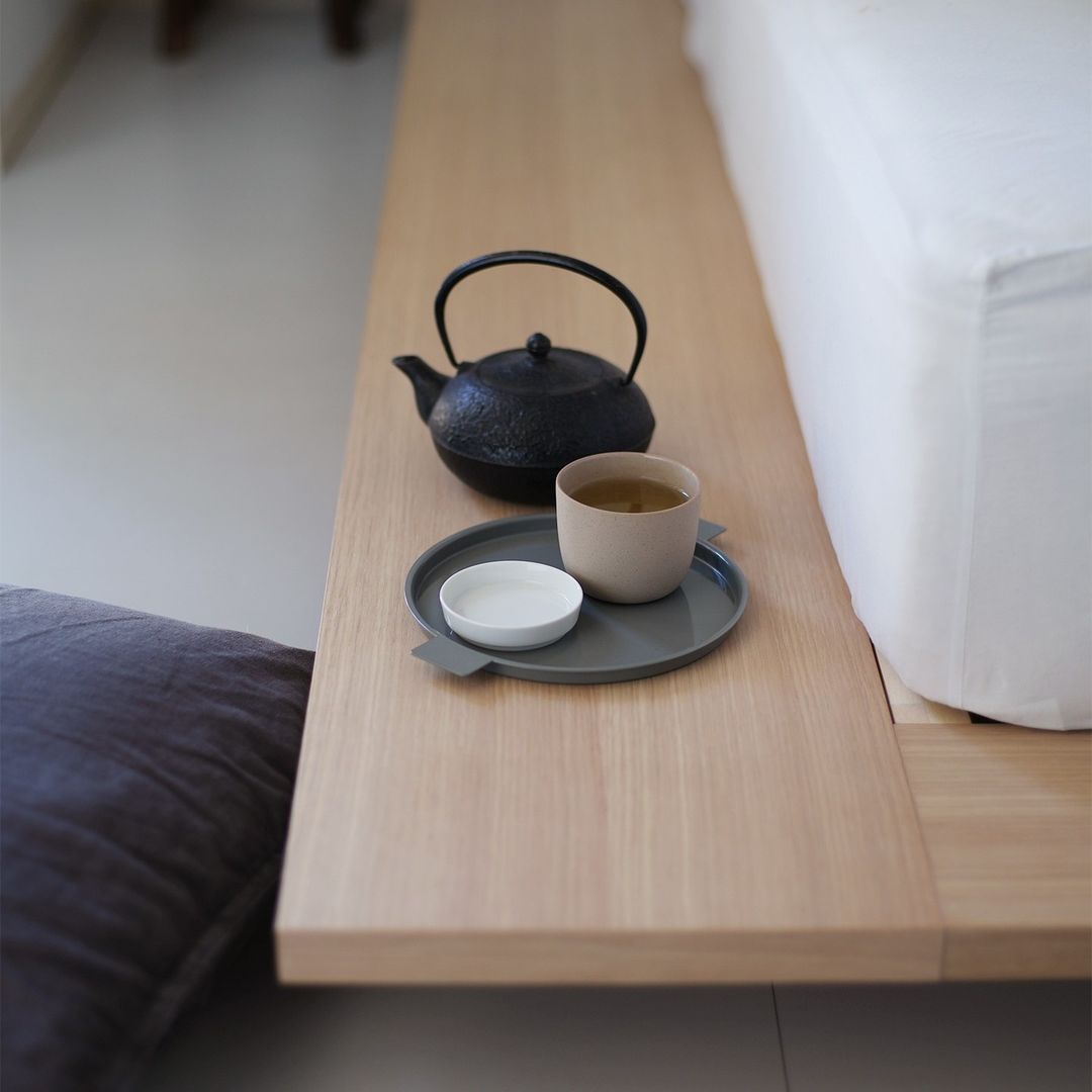 A minimalist tea set on a wooden bench