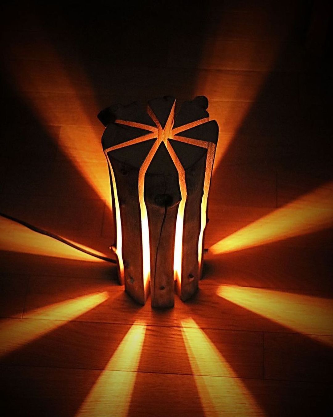 A lamp casting a dramatic star-shaped pattern on the floor