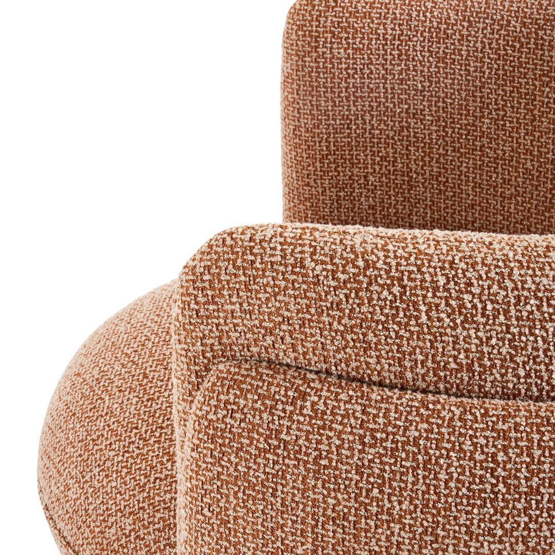 A comfortable looking armchair with textured brown upholstery