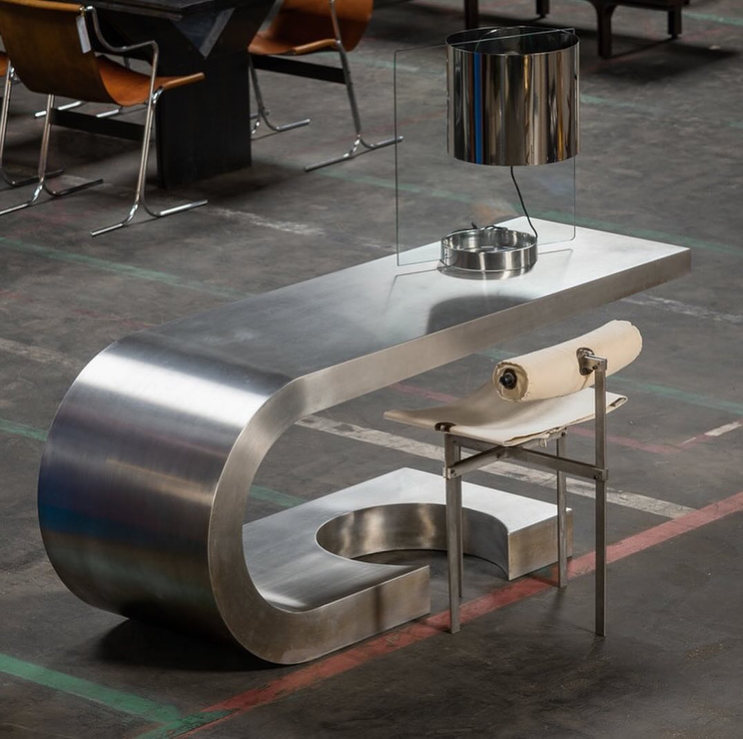 Stylish metallic desk with a unique curved structure