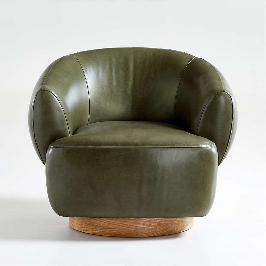 Stylish modern olive green leather chair with a curved silhouette and a round wooden base