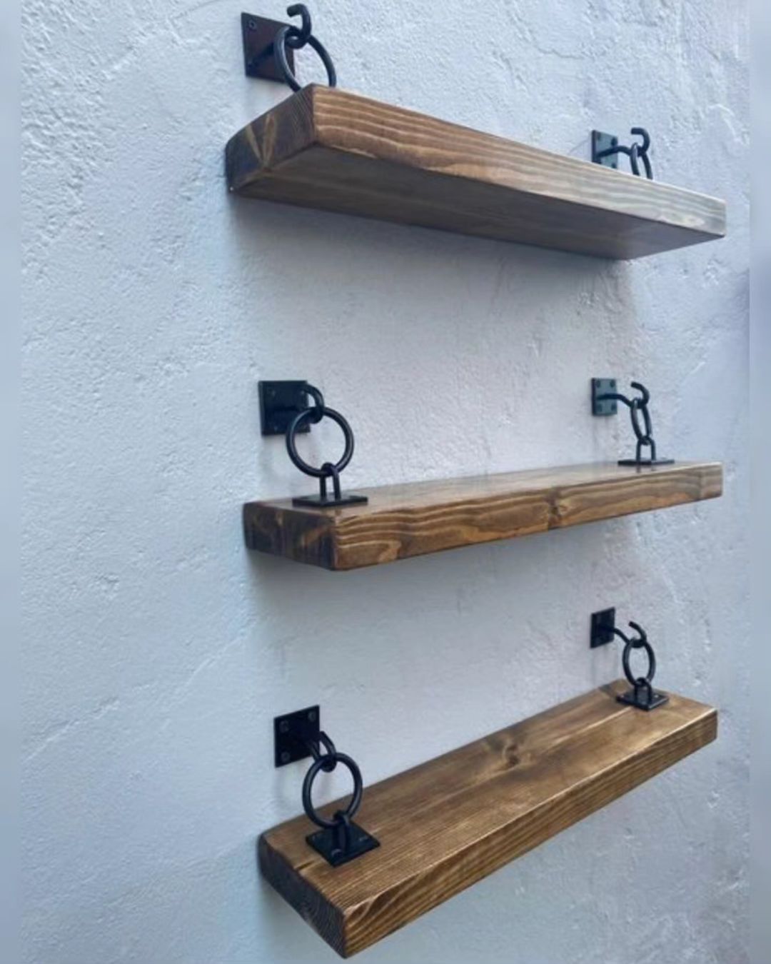 Stylish wall-mounted shelves featuring a rustic wooden finish and industrial metal brackets