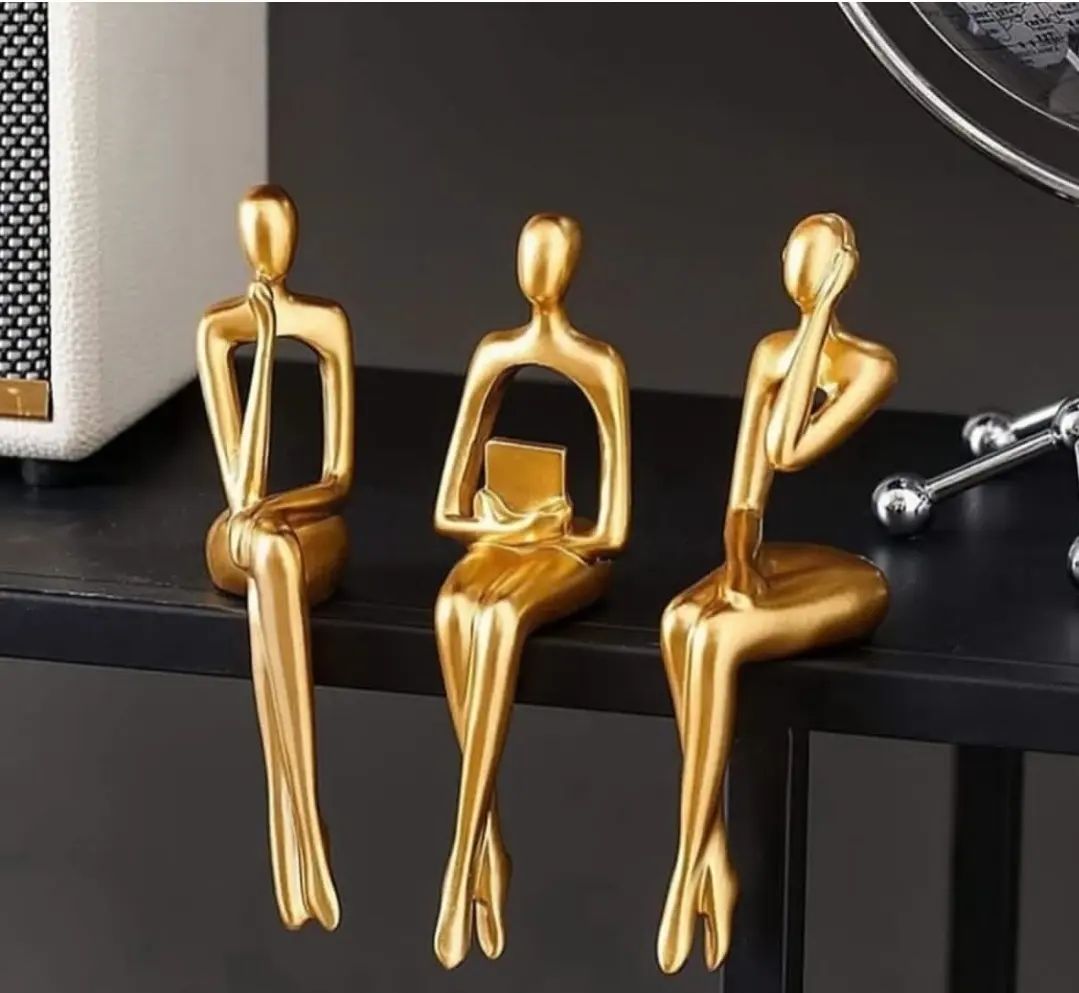 Abstract Golden Figurines Sitting on a Shelf