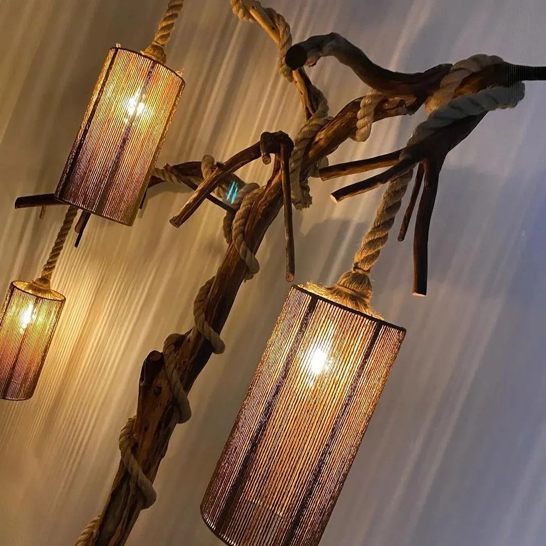 A creatively designed chandelier with intertwined ropes and rustic wood