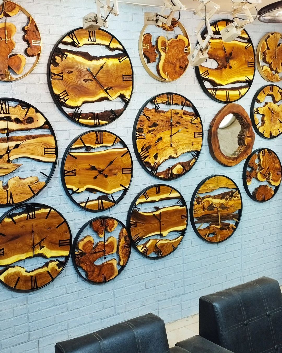 A visually striking collection of wood slice wall clocks with various organic patterns, creating a rustic yet modern ambiance in the room.