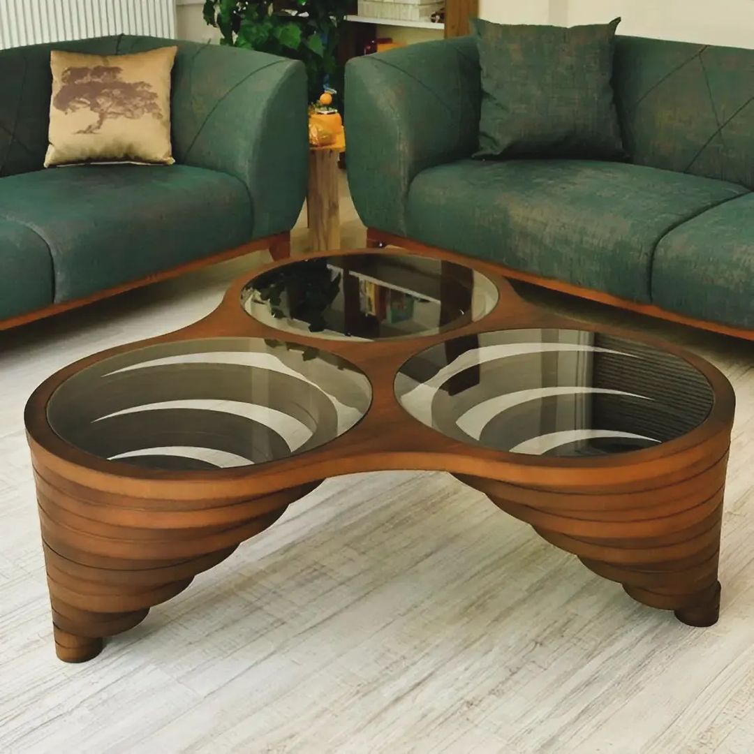 A unique wooden coffee table with glass insets shaped like interconnected rings, bringing a touch of modern artistry to the living room