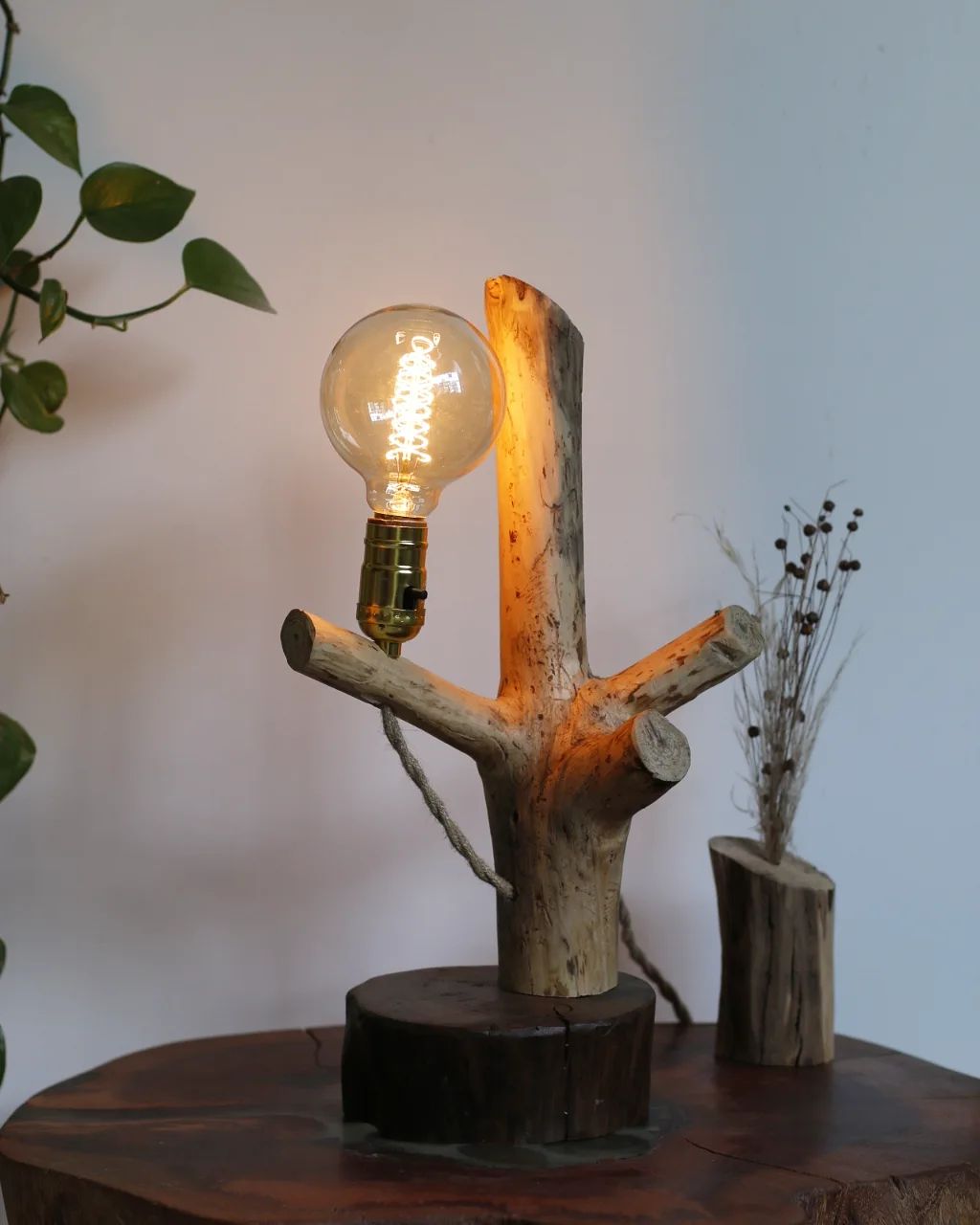 A unique wooden table lamp with exposed bulb