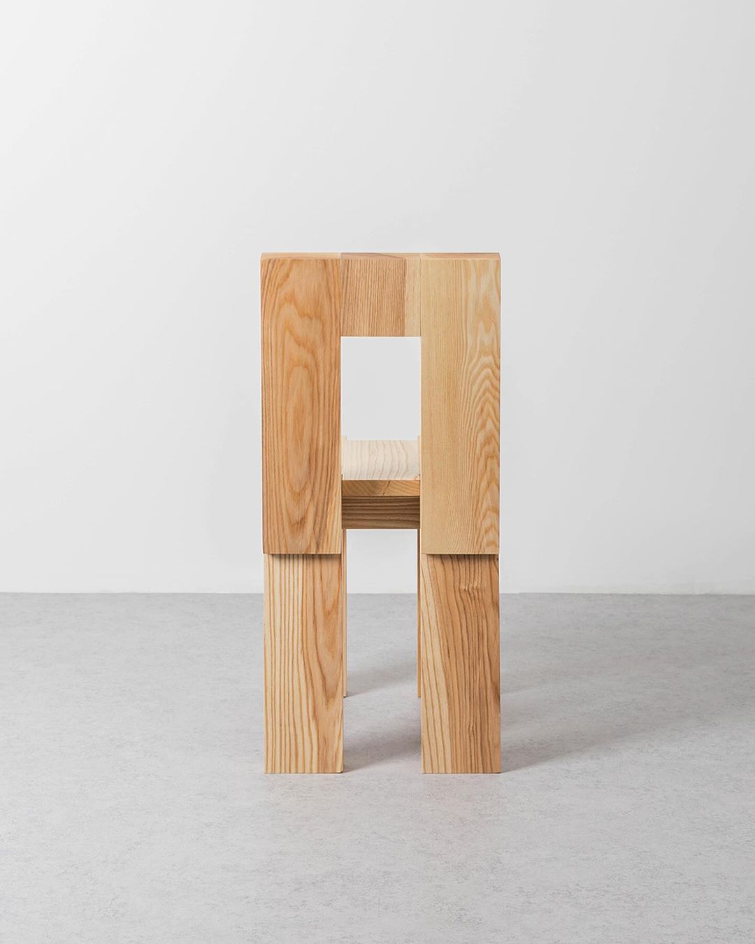 A uniquely structured wooden chair with a bold geometric design