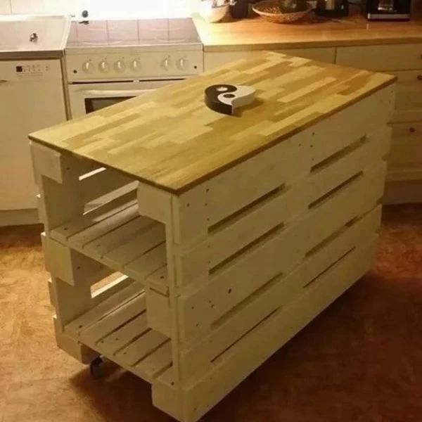 A creatively upcycled wooden kitchen island with integrated racks and a yin-yang symbol on the countertop