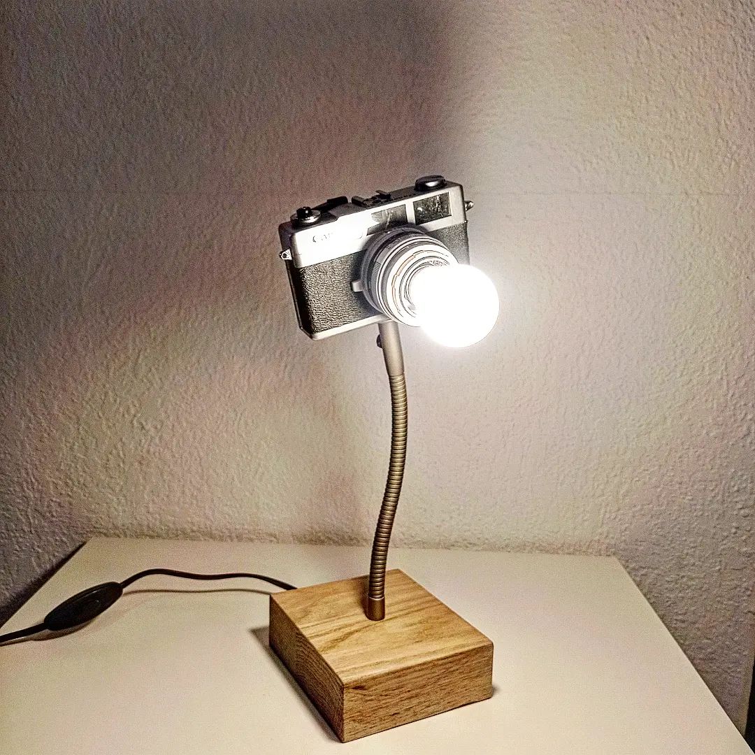 A unique lamp fashioned from a vintage camera, poised as if capturing the room's essence