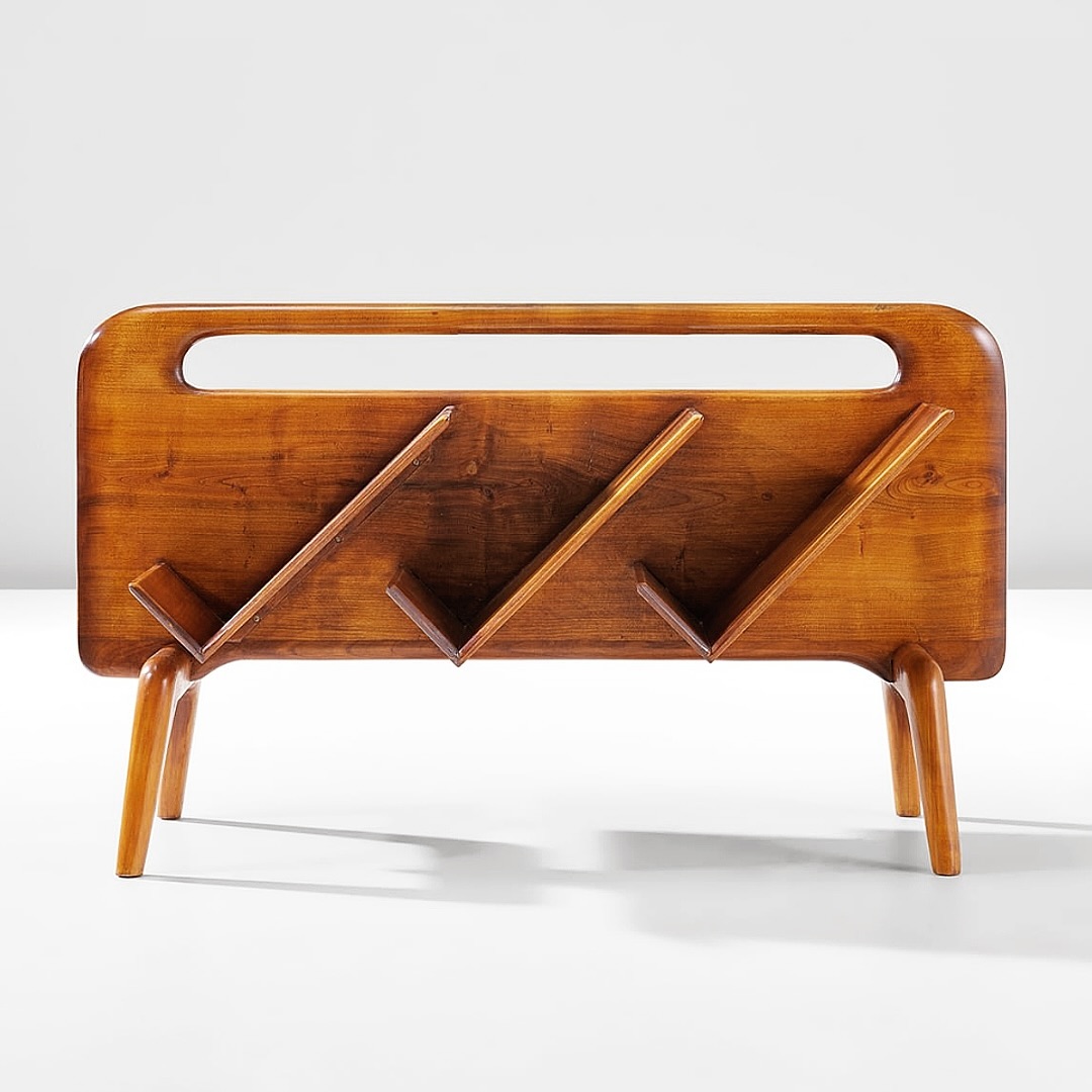 A vintage wooden magazine rack with a unique design