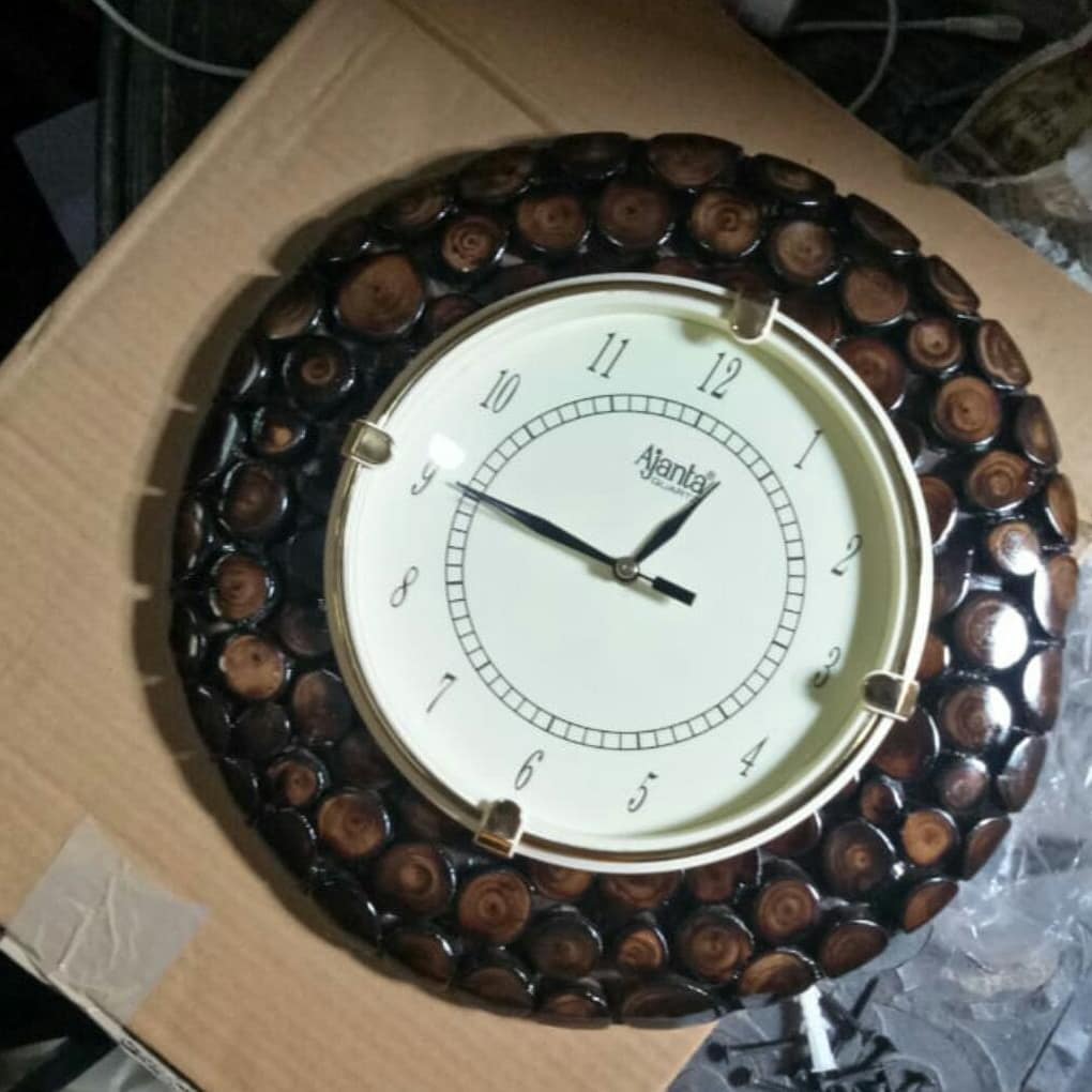 A unique wall clock encased in a frame adorned with polished nut shells