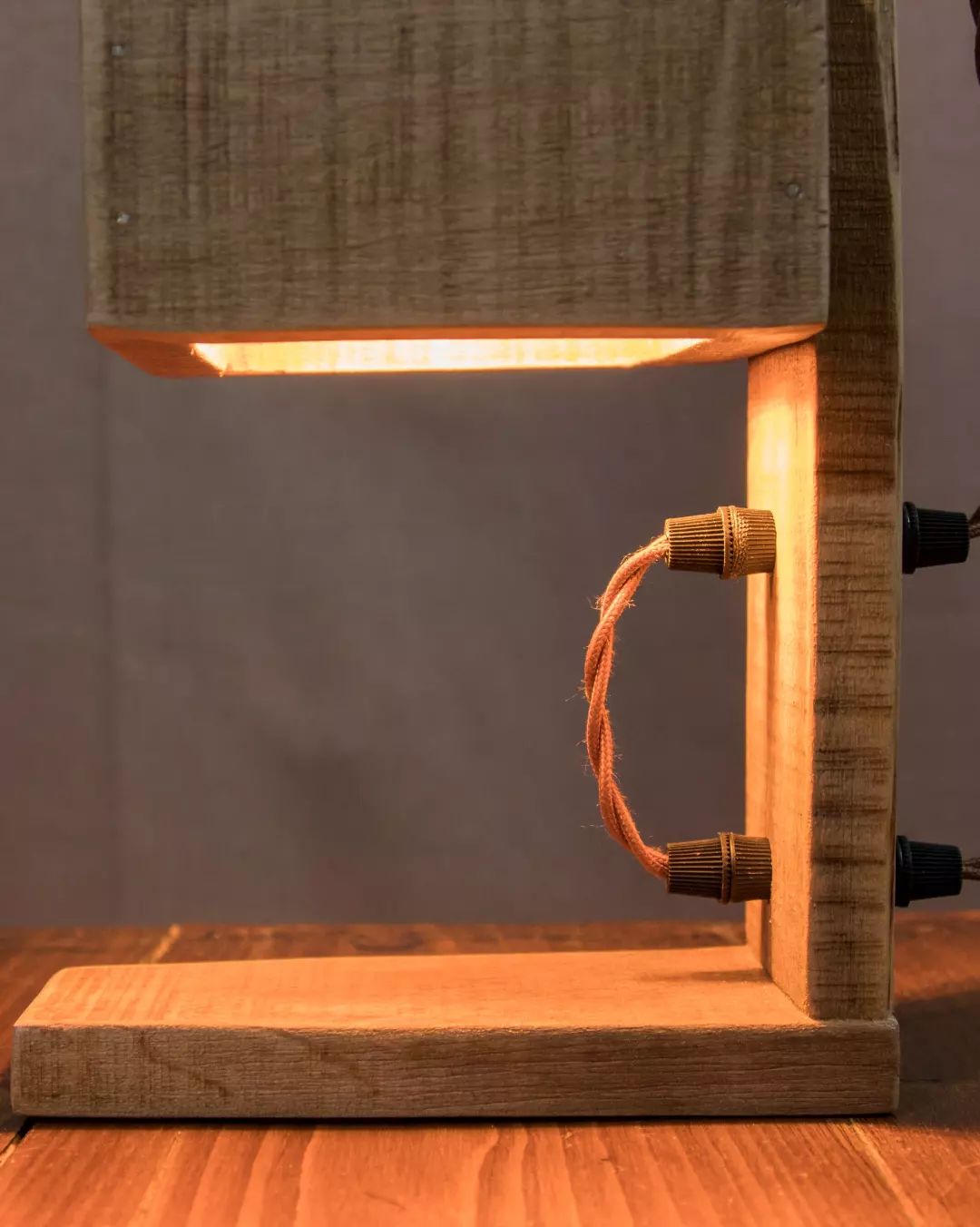 Warm-toned wooden lamp with a beige shade and a braided cord switch