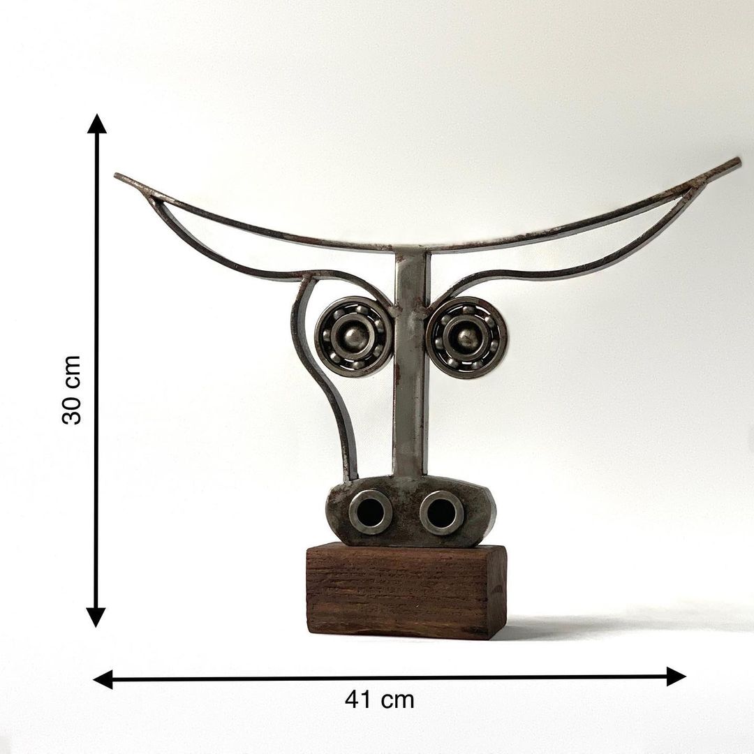 Unique metal sculpture with whimsical facial features