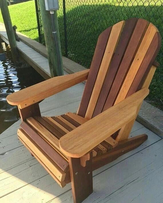 A uniquely designed wooden Adirondack chair by the waterfront