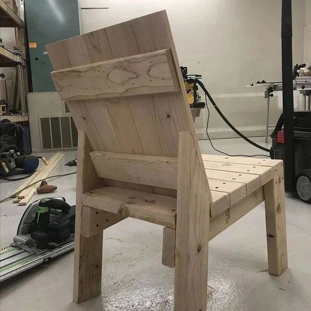 A uniquely crafted wooden chair with an unconventional tall backrest