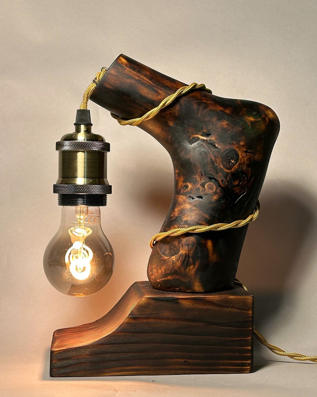 A unique lamp designed with a wooden human foot shape