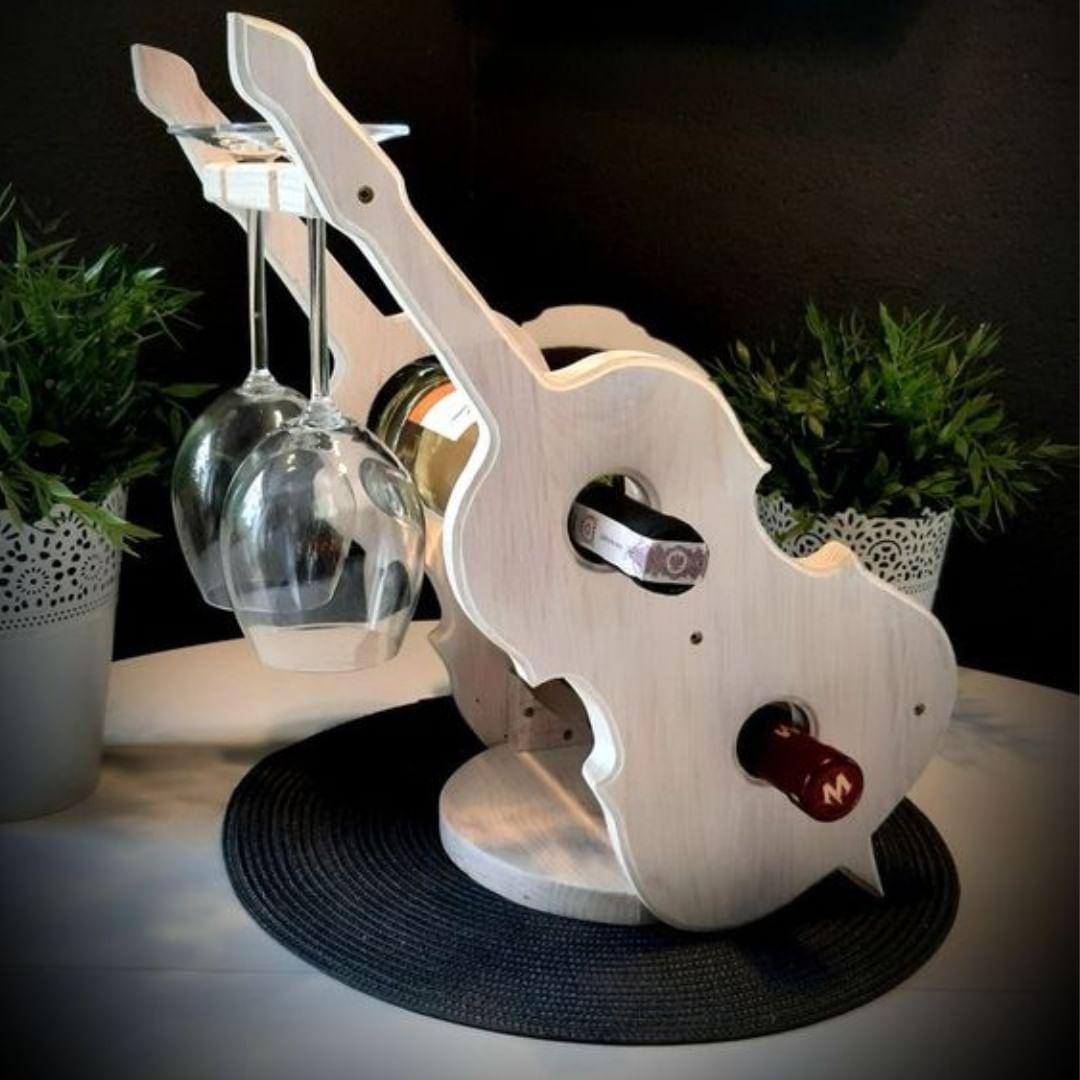 A wooden wine bottle and glass holder shaped like a guitar