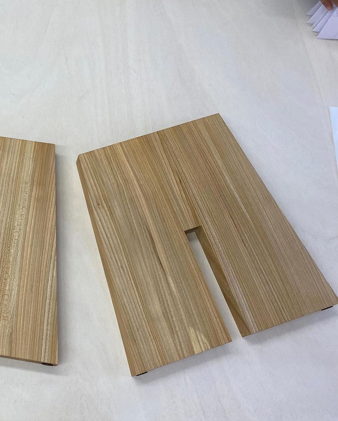 Two wooden laminate samples with a cutout