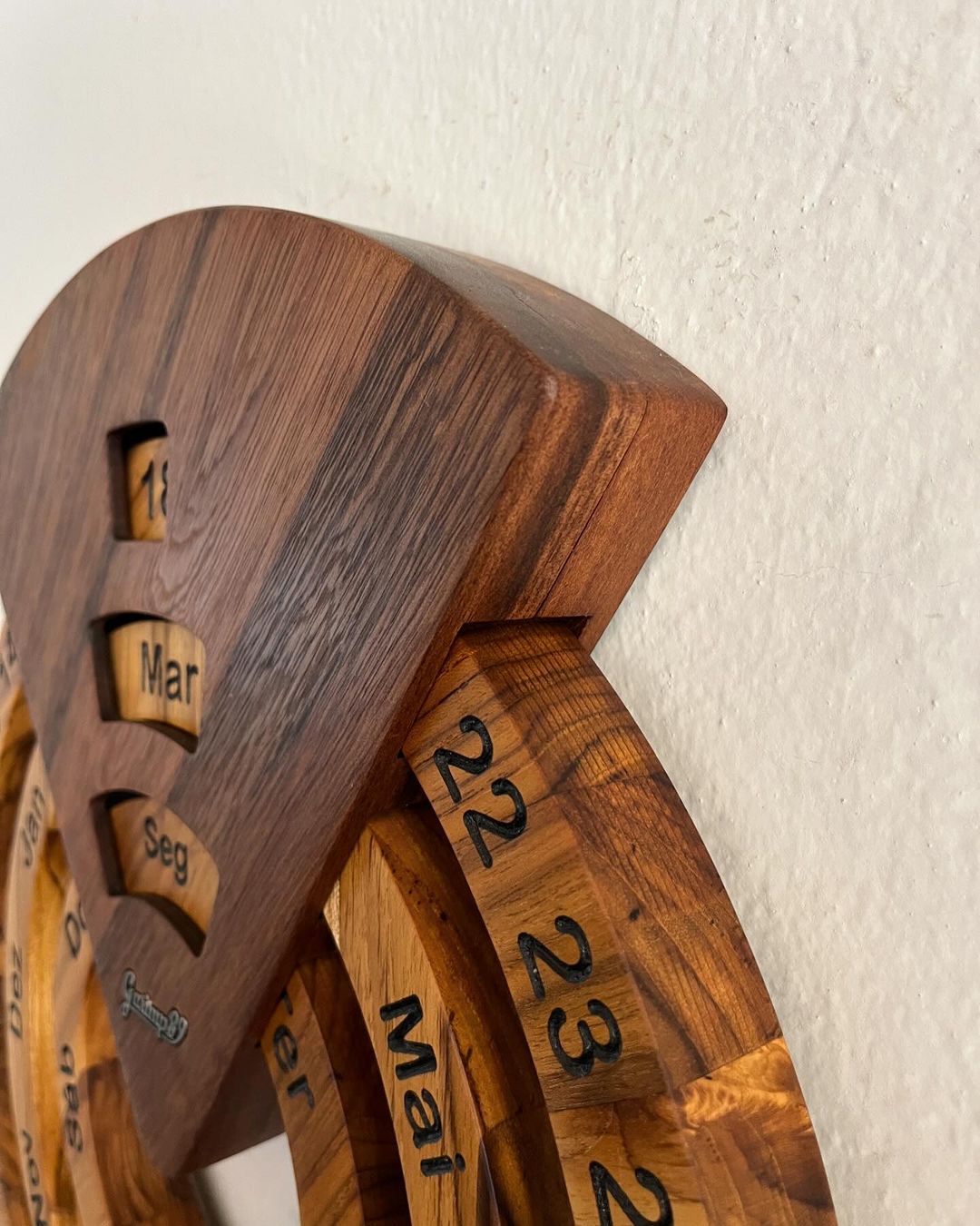 Perpetual wooden calendar mounted on a wall