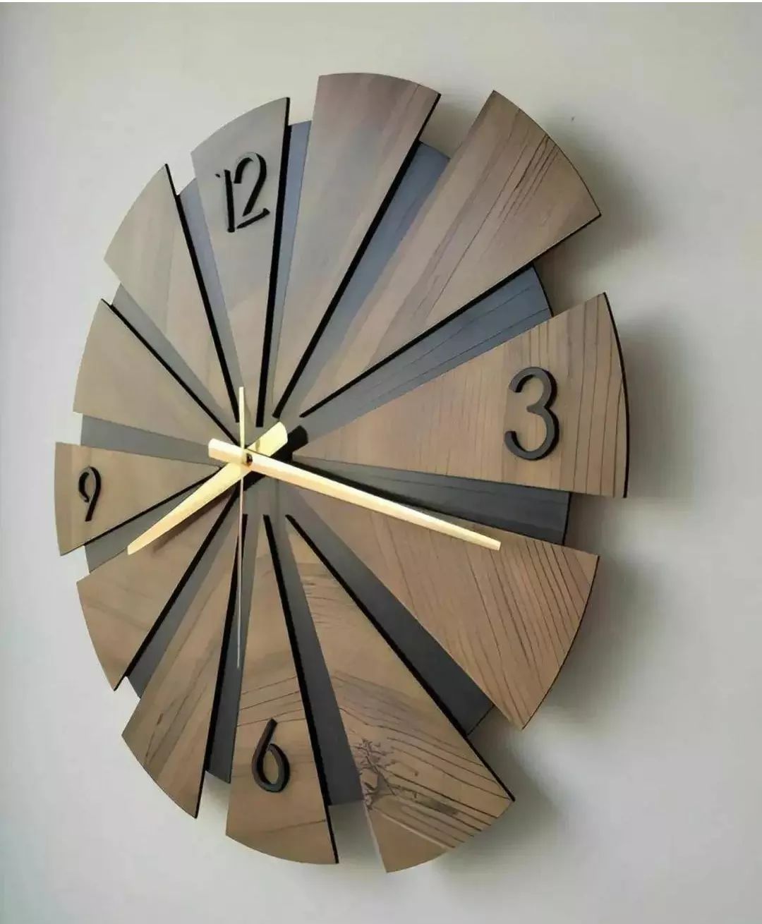 A creatively designed wooden wall clock with alternating dark and light wood segments, resembling a circular saw blade.