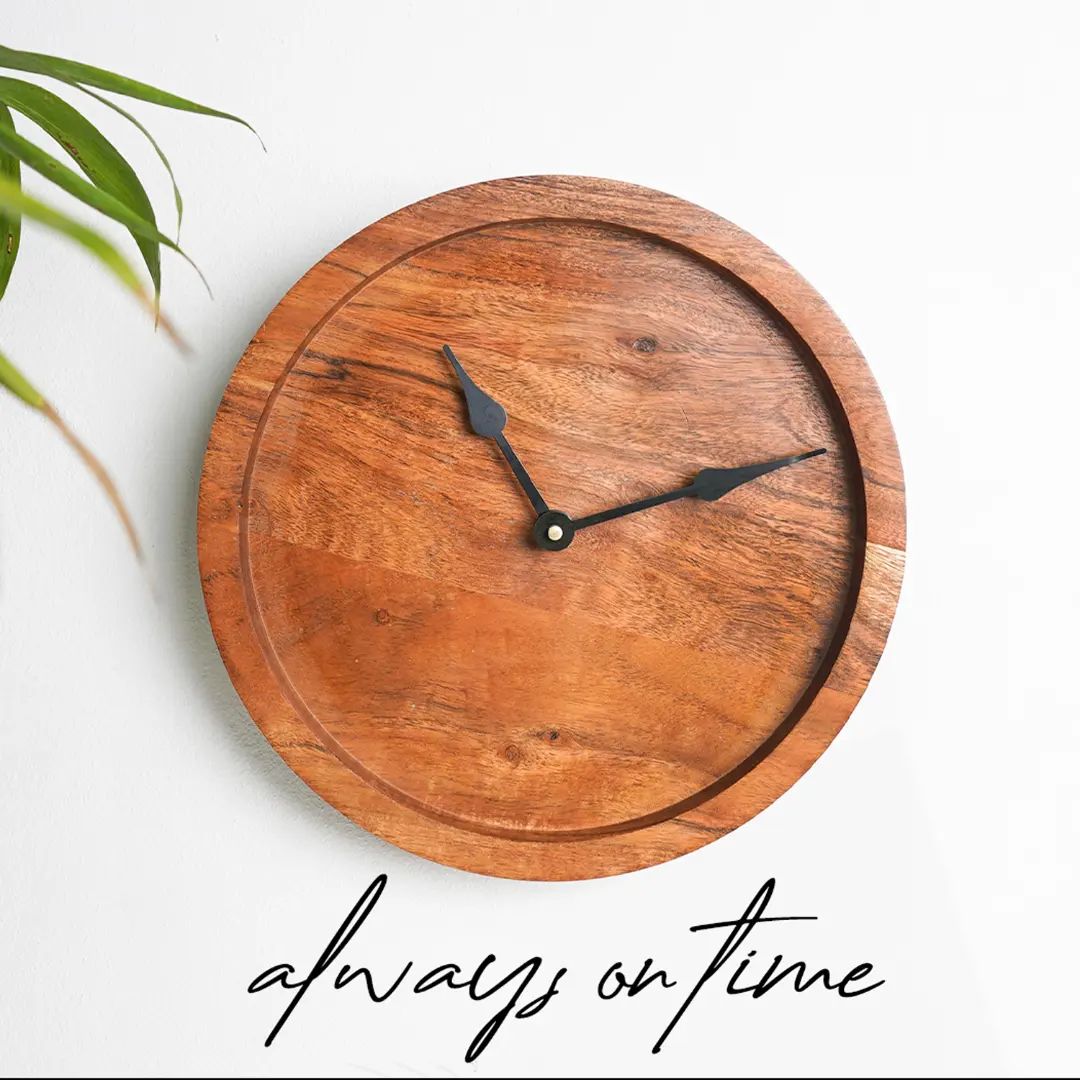 A minimalist wooden wall clock with sleek black hands