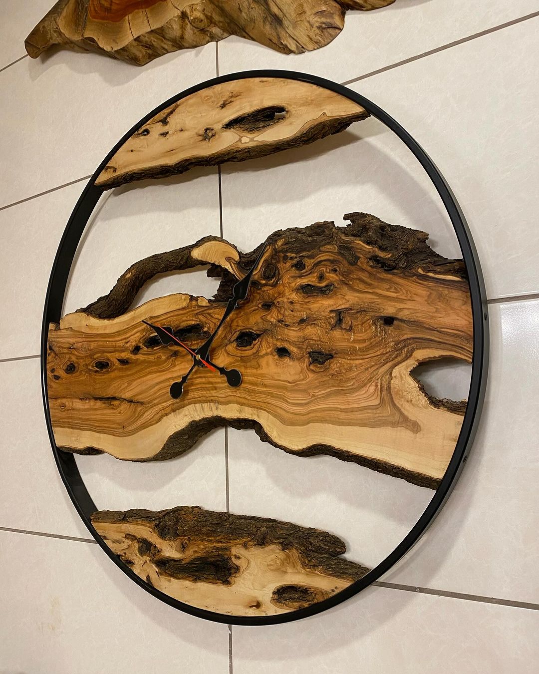 A unique wall clock featuring an intricate wooden design within a circular frame