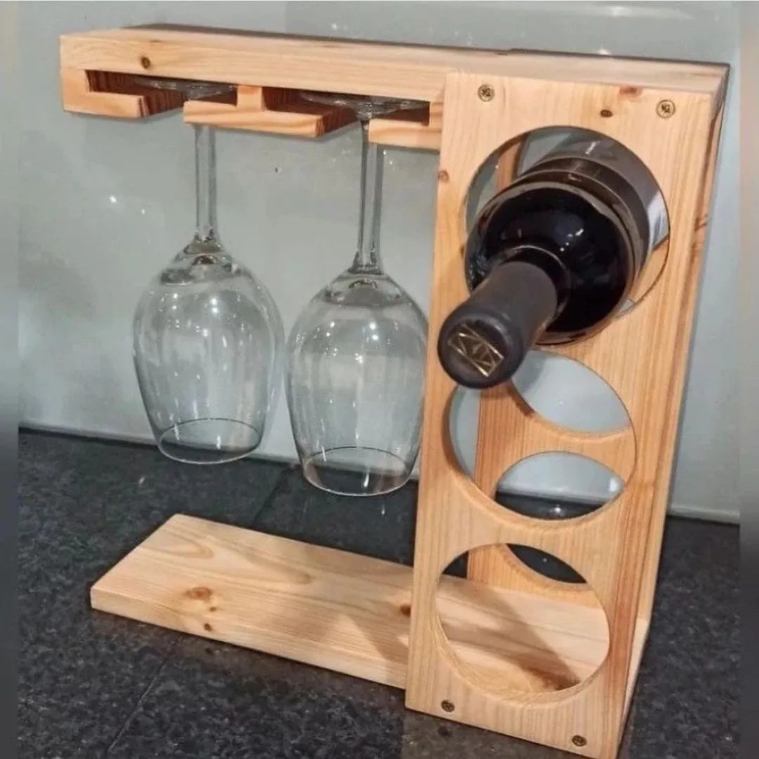 A creative wooden wine holder with an upside-down bottle and suspended glasses